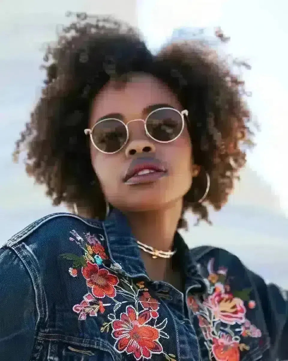 Diverse women in embroidered denim jackets by Philadelphia's Liberty Bell. Spring season.