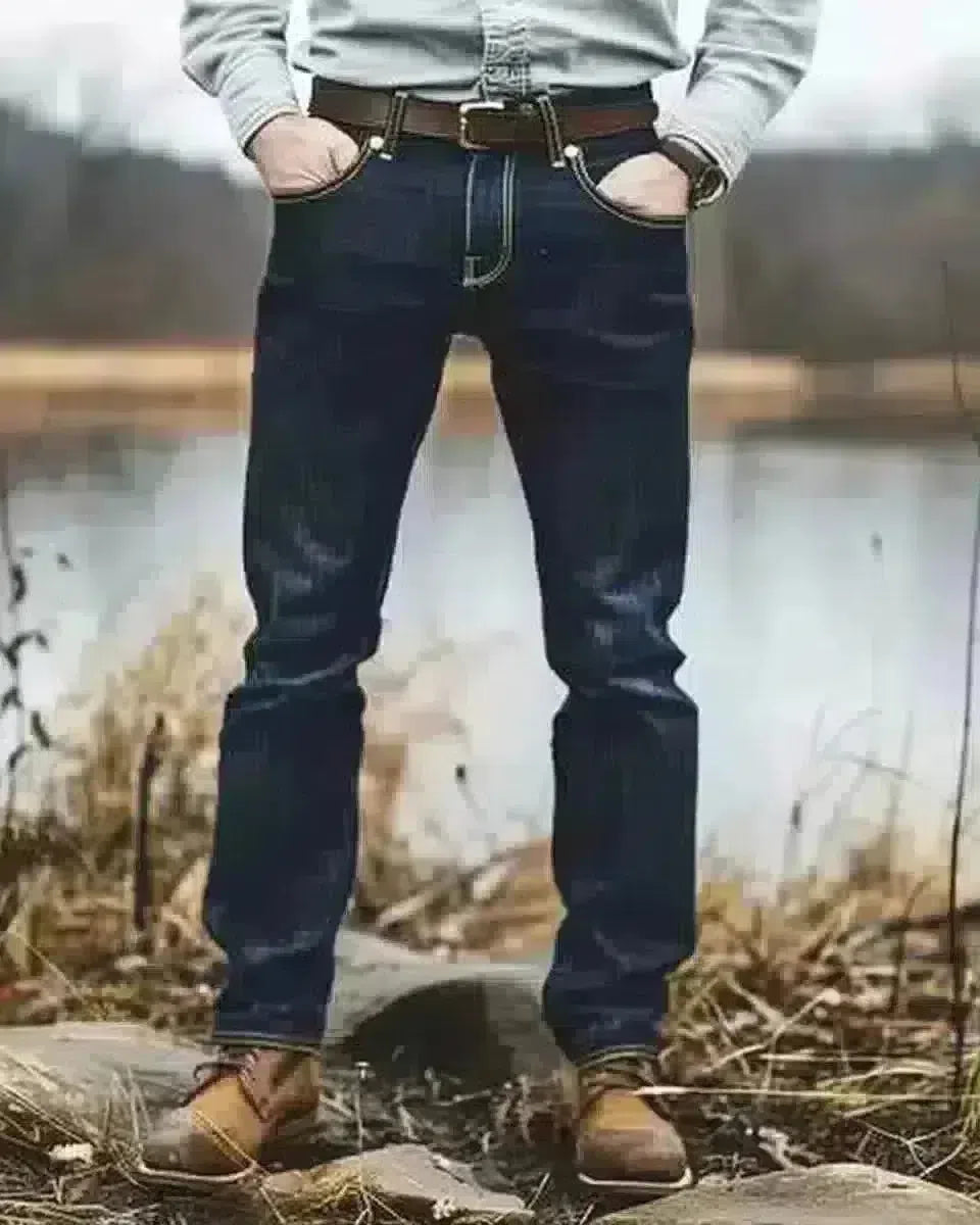 Man in dark blue jeans, autumn outdoor setting, relaxed vibe. Spring season.