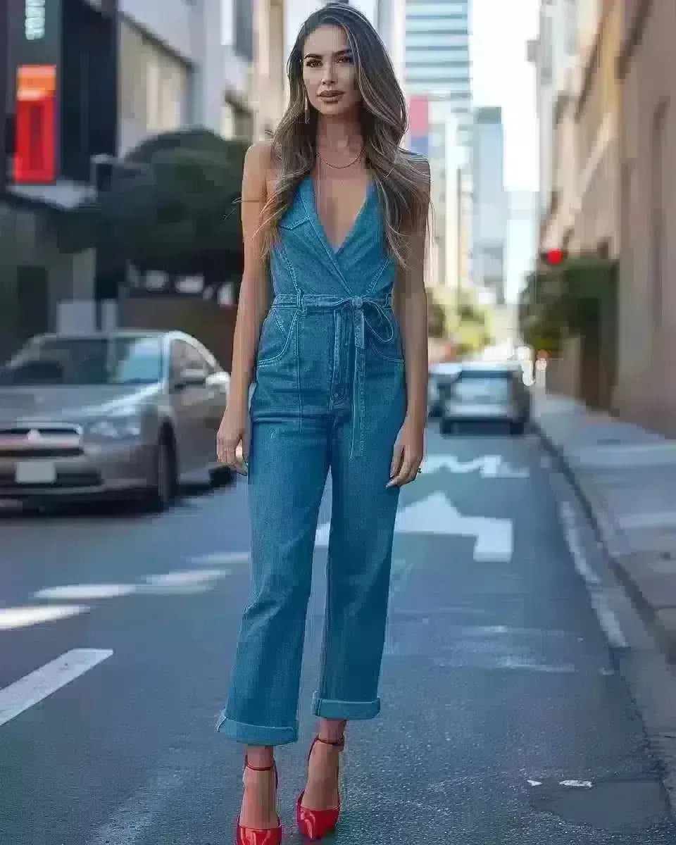 Hispanic woman in chic denim jumpsuit with red heels on sunny Queensland street. Winter  season.