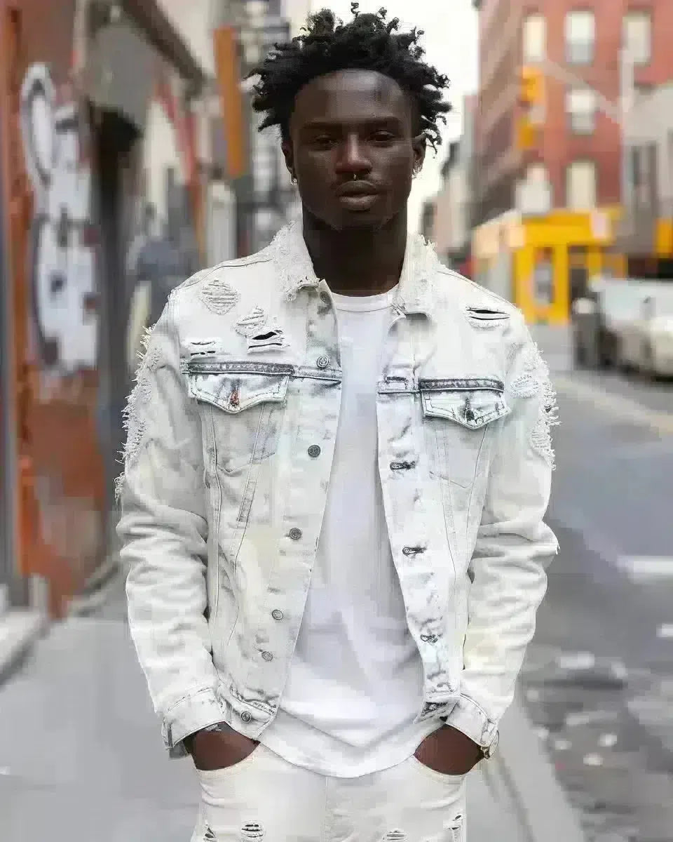 Diverse male model in embroidered denim jacket and white pants, urban background. Spring season.