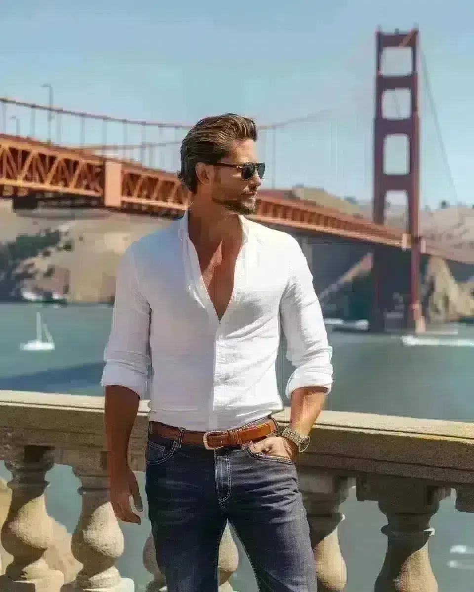 Stylish man in dark-wash jeans and white shirt at Golden Gate Bridge. Late Winter  season.