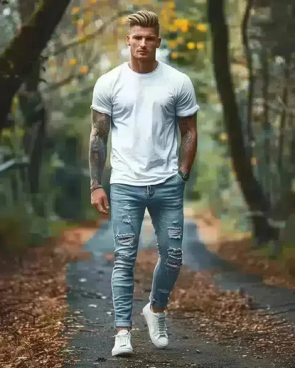 Yorkshire outdoor fashion shoot, man wearing blue ripped jeans and white cotton t-shirt. Spring season.
