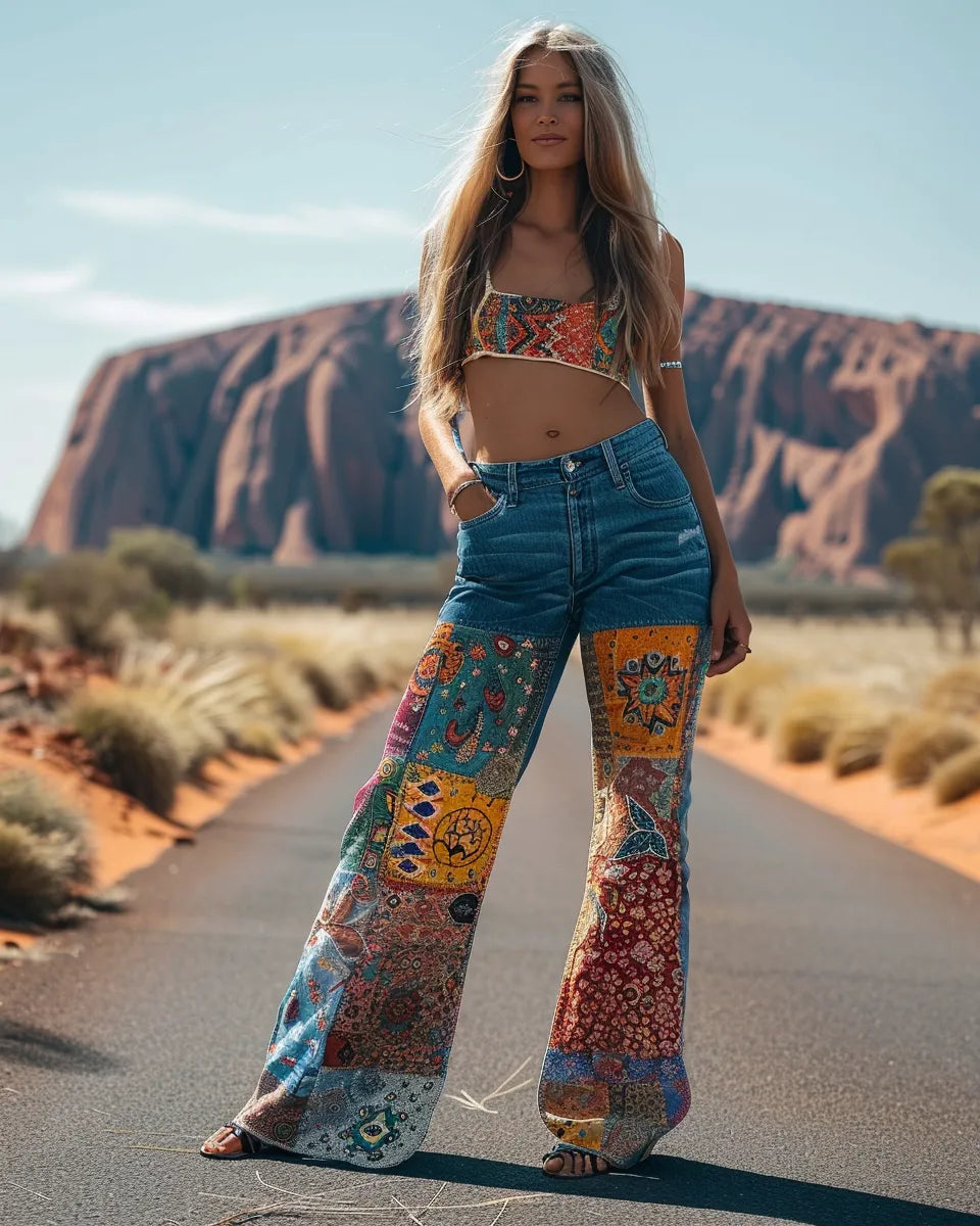 Colorful women's patchwork jeans blend Eastern and Western styles with intricate Asian patterns and classic denim. Summer season. English female. Uluru (Ayers Rock), Uluru city background.