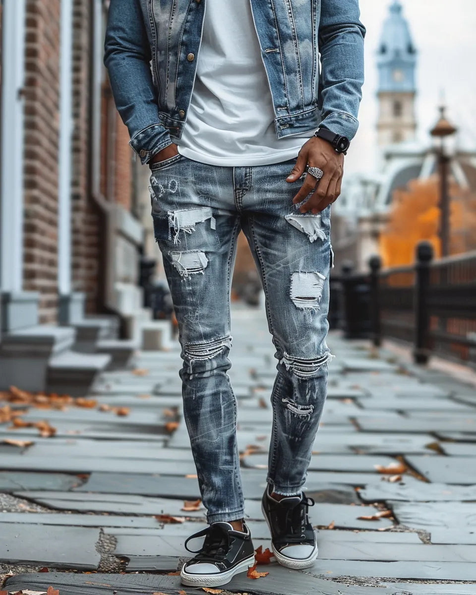 Men's grey ripped jeans, featuring distressed details, paired with a white tee, blue denim jacket, and black sneakers. Autumn season. Chinese male. Independence Hall, Philadelphia, PA background.