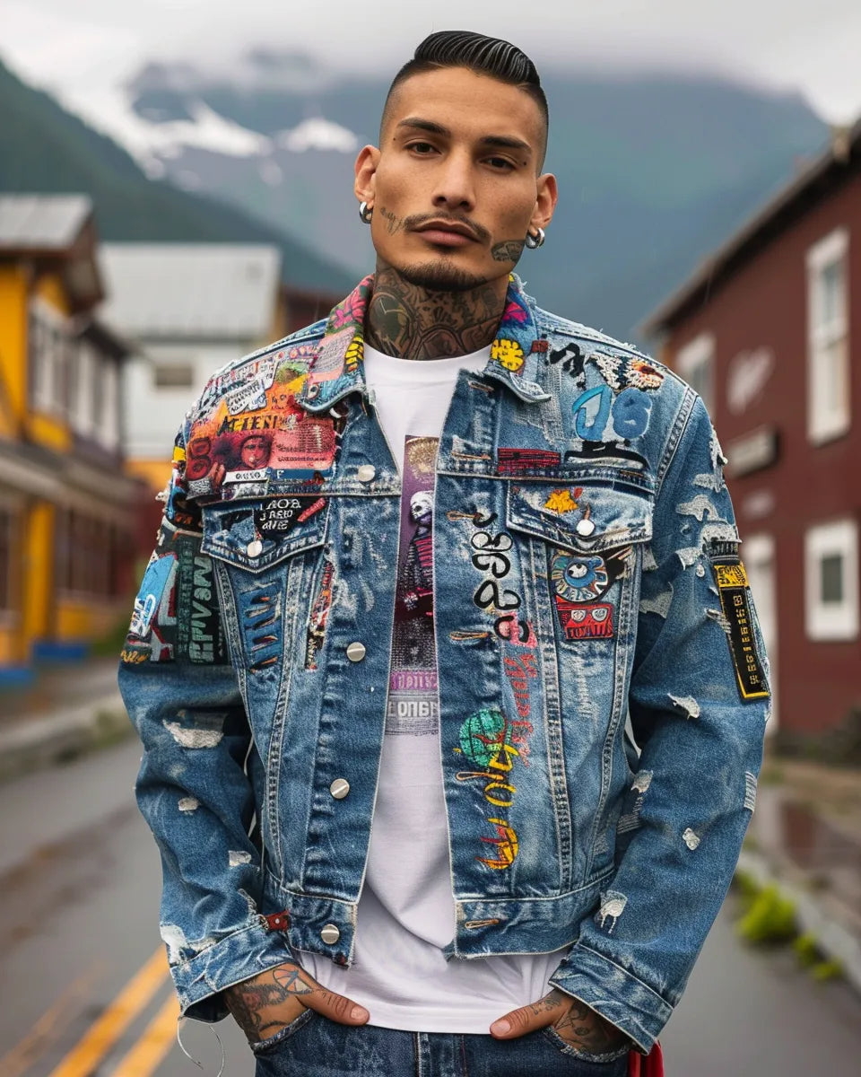 Model in an urban setting wearing an oversized denim jacket with bold patches and graffiti-style designs. Summer season. Latino male. Kenai Fjords National Park, Seward, AK city background.