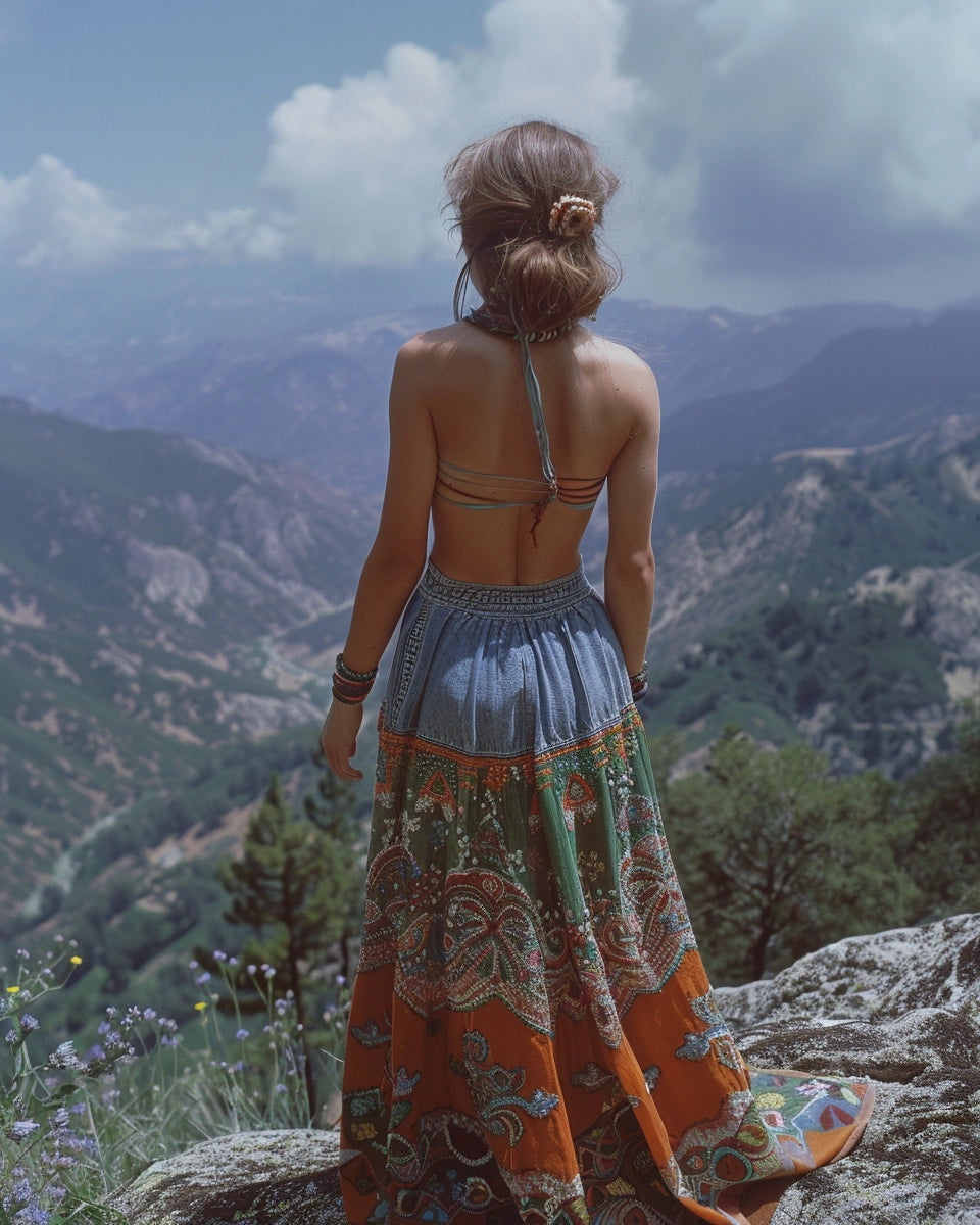 1970s bohemian embroidered denim skirt, intricate patterns, modern chic style centerpiece. Spring season. English person. Sequoia and Kings Canyon National Parks, Sierra Nevada, CA city background.
