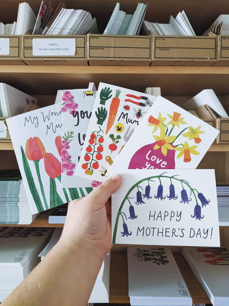 I am holding five cards suitable for Mother's Day, featuring floral designs