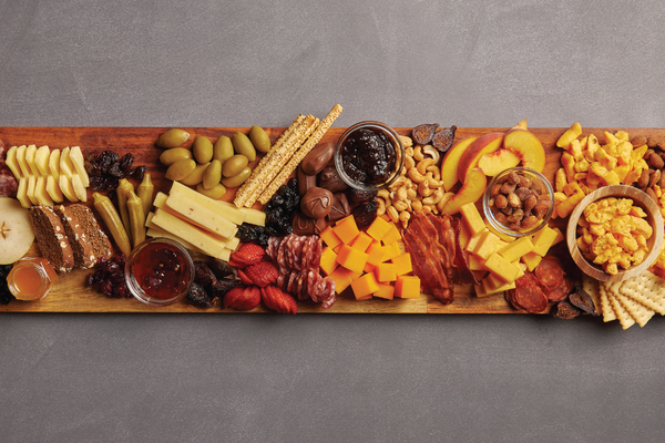 Image of extra tidbits being added to cheese board