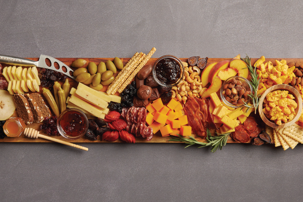 Image of garnishes being added to cheese board