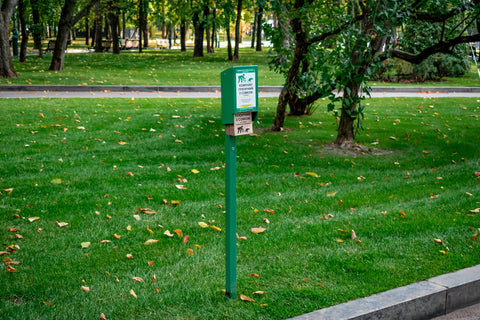 Dog poop bag dispense in a green grassy park