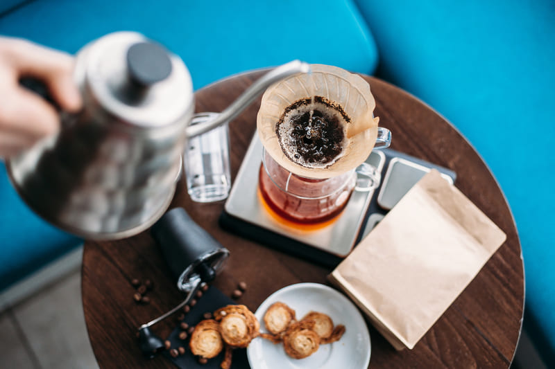 filter-coffee-hand-drip-coffee-barista-pouring-water-on-coffee-ground-with-filter