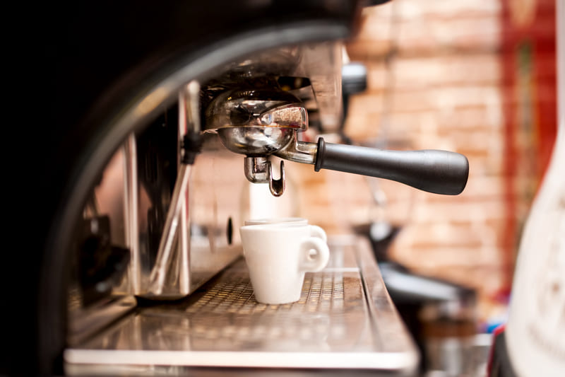 machine-coffee-syrup-preparing-espresso-in-coffee-shop