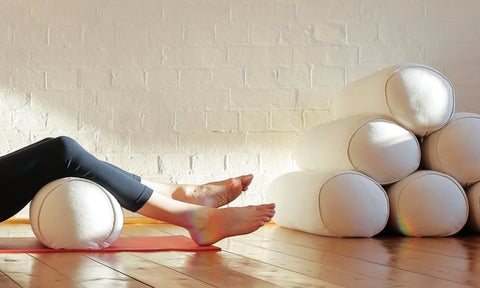 La posture du cadavre (Savasana) avec un bolster