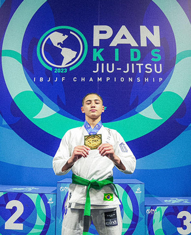 Yoshito holding Pans medal while wearing Gameness BJJ gi.