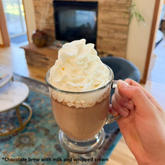 glass mug of brewed cacao with whipped cream