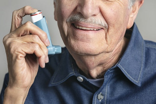 old man using inhaler