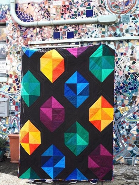 Facets modern gemstone quilt pattern by Monika Henry of Penny Spool Quilts - Quilt featuring modern, simplified gemstones in a variety of colours on black background
