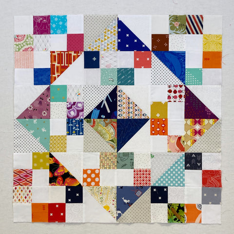 Square Confetti Quilt by Penny Spool Quilts - charity baby quilt in multicolor on white background