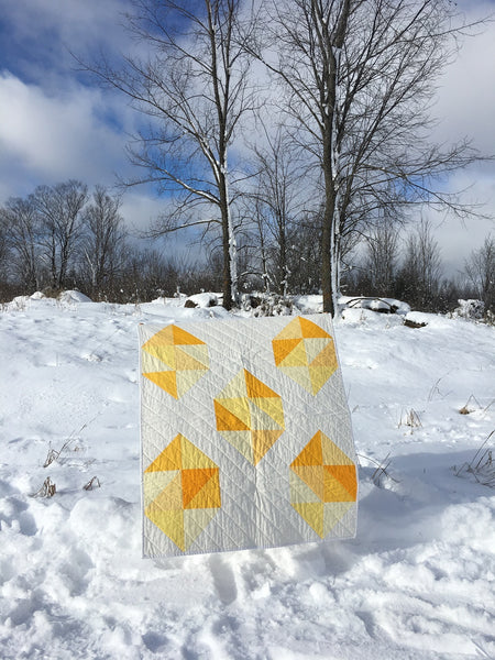 Facets modern gemstone quilt pattern by Monika Henry of Penny Spool Quilts - Quilt featuring modern, simplified yellow gemstones on white background.