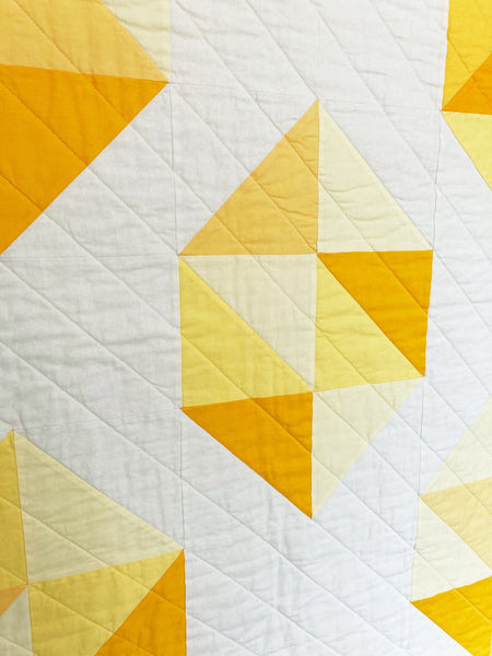 Facets modern gemstone quilt pattern by Monika Henry of Penny Spool Quilts - Quilt featuring modern, simplified yellow gemstones on white background.