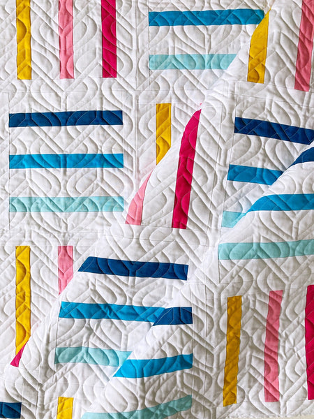 Bar Code quilt pattern by Monika Henry of Penny Spool Quilts - pink, yellow and blue bars on white background, square throw