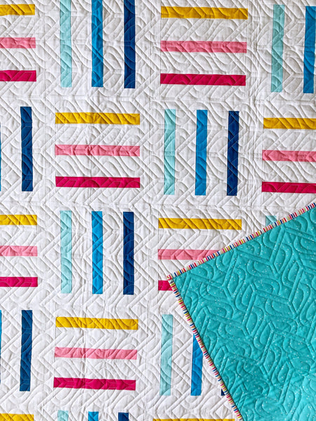 Bar Code quilt pattern by Monika Henry of Penny Spool Quilts - pink, yellow and blue bars on white background, square throw