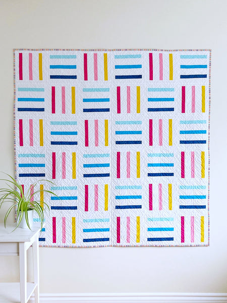 Bar Code quilt pattern by Monika Henry of Penny Spool Quilts - pink, yellow and blue bars on white background, square throw