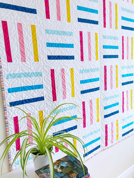 Bar Code Quilt pattern by Penny Spool Quilts - throw quilt in multicoloured stripes on white background, with turquoise backing