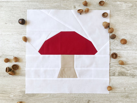 Mushroom FPP quilt block pattern by Penny Spool Quilts - mushroom in solid fabrics with red cap and tan stem, white background
