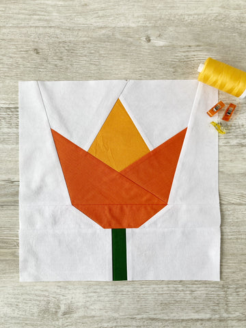 Tulip FPP quilt block pattern by Penny  Spool Quilts - sample in orange on white background