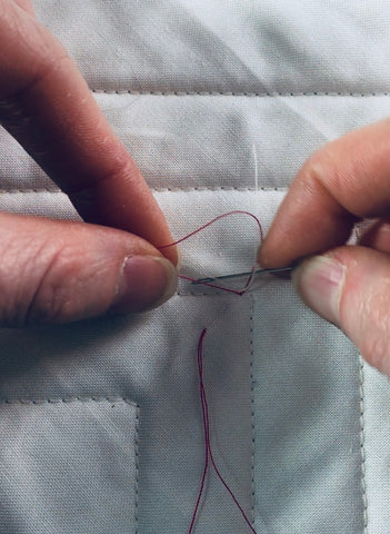 How to bury short threads, a quilting tutorial by Penny Spool Quilts - pull the quilting threads through the loop