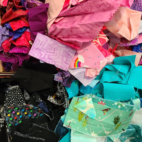 Pile of scrap fabrics in pink, turquoise and black