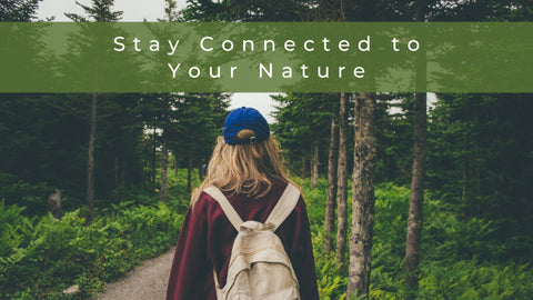 Stay connected to nature wherever you go woman standing in forest on a hike