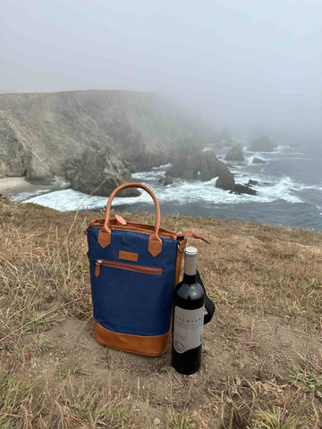 Tirrinia Red wine bag on sand next to sea water