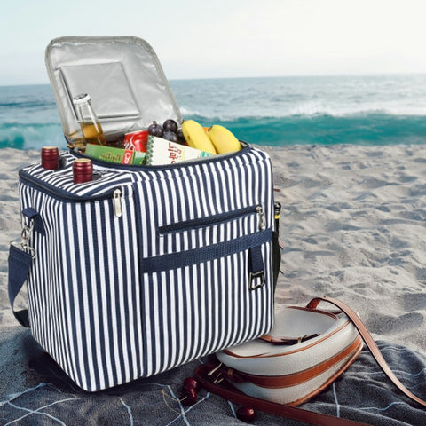 At the beach, a large insulated picnic bag on a picnic mat
