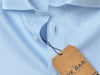 Blue button down shirt with a Tie Bar hang tag