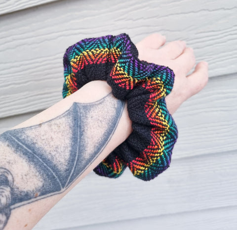 arm wearing handwoven scrunchie in rainbow LGBTIQ colours