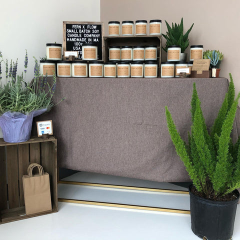 Fern x Flow handmade 100%, soy candles on a table display for sale at Meraki Spa in Lynnfield, MA