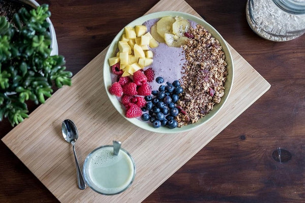 A bowl of overnight oats with granola, berries, and fruit.