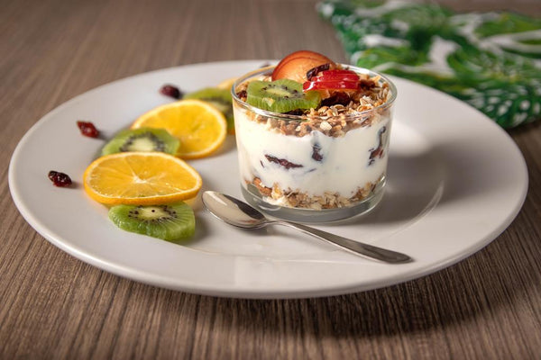 Greek yogurt topped with fruits and granola.
