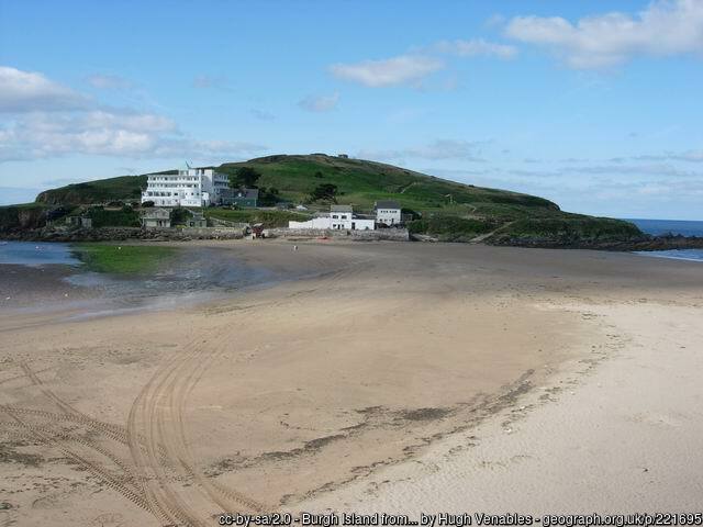 Bigbury beach on a calm day with Burgh island in the background and the pilchard hotel