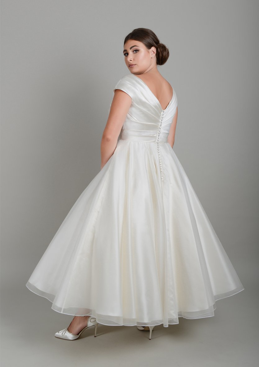 A classic fifties wedding gown with pleated satin wrap bodice