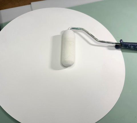 Painting a white round wood disc