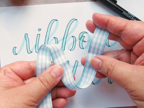 Ribbon hand lettering mimicking real ribbon 