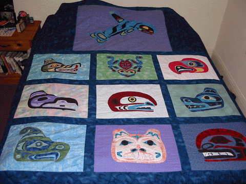 Multi-color patch quilt with Native American animal art styles.