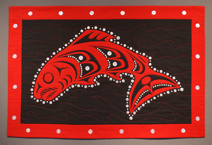 Red and black Northwest Coast style button blanket, Native American style quilt with Pacific Northwest Native American salmon art style design.