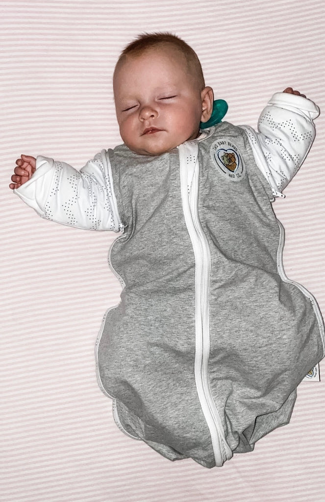 baby sleeping in swaddle sleeves sack