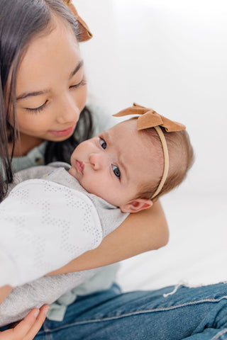 girl holding baby looking at camera