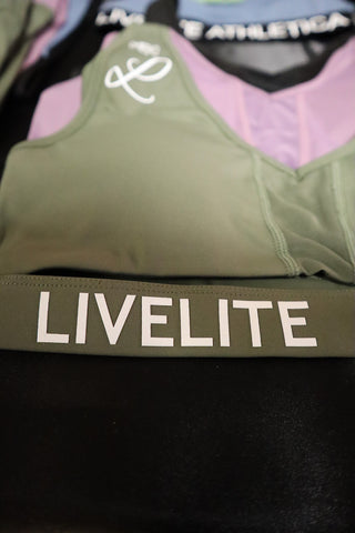 Livelite Flawless Luxury sports bras in Forest, Noir Black, and Mauve showcased at the Vancouver Fall Classic body building show.