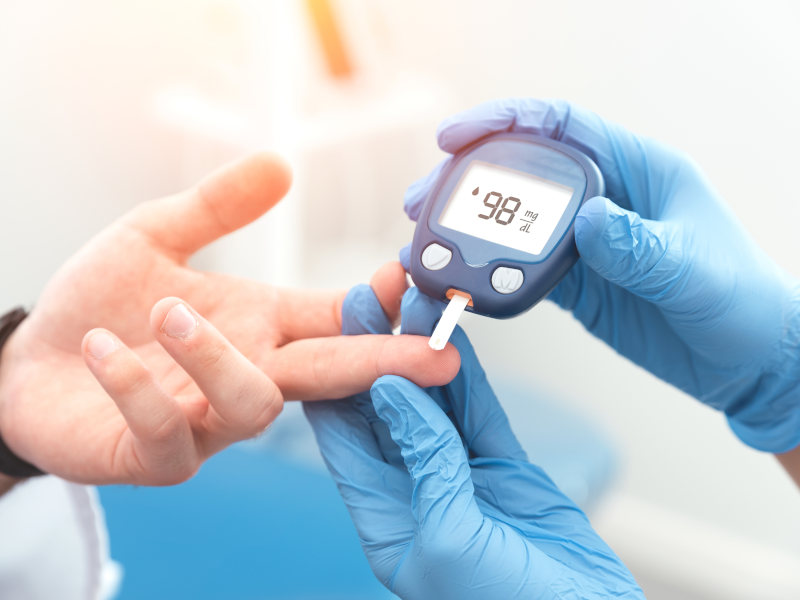 Doctor checks diabetes patient's blood sugar